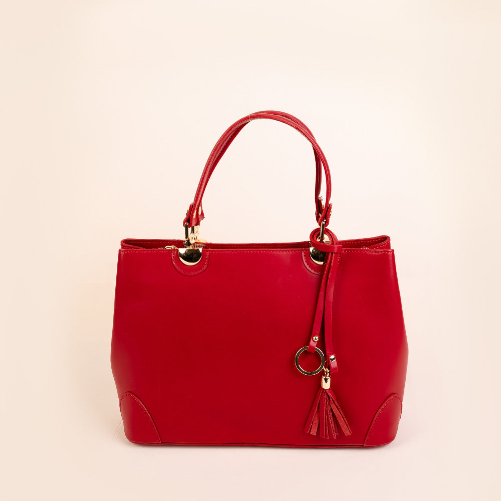 SEMI-RIGID HANDBAG WITH CORNER PROTECTORS AND TASSEL