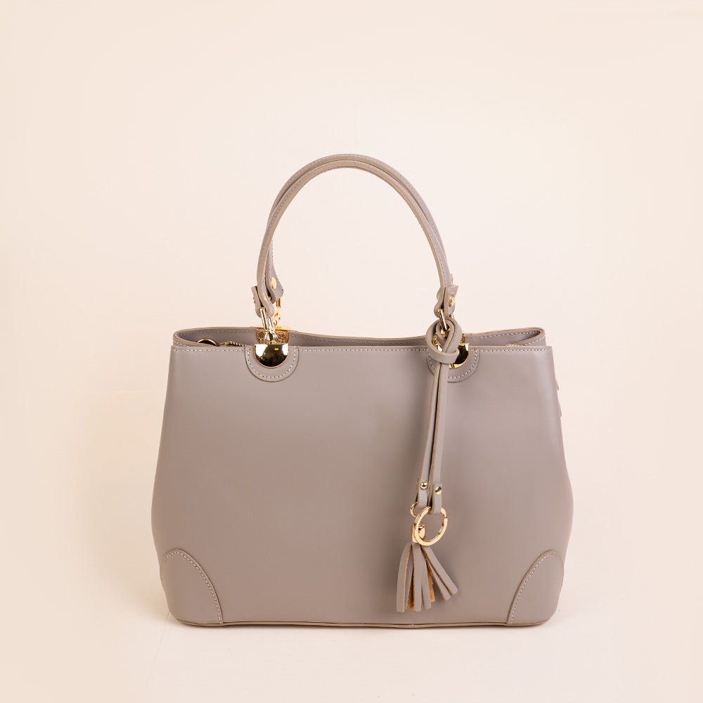 SEMI-RIGID HANDBAG WITH CORNER PROTECTORS AND TASSEL