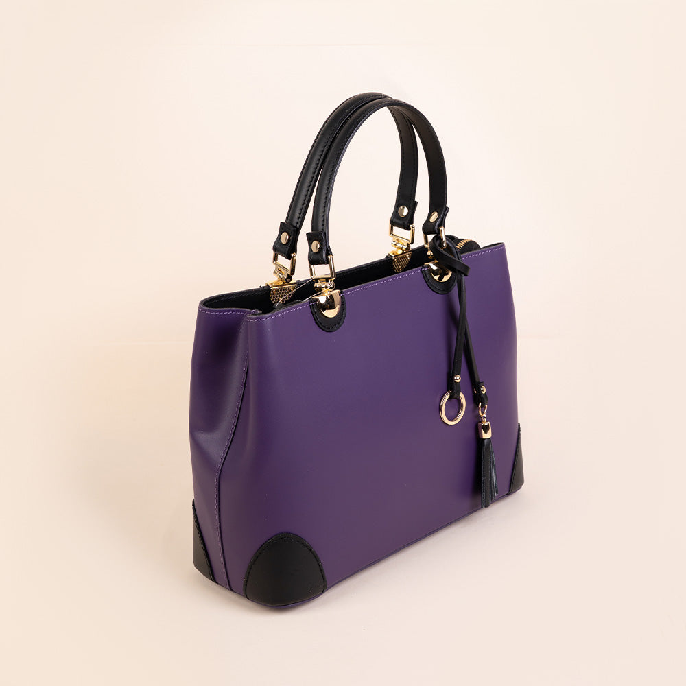 SEMI-RIGID HANDBAG WITH CORNER PROTECTORS AND TASSEL