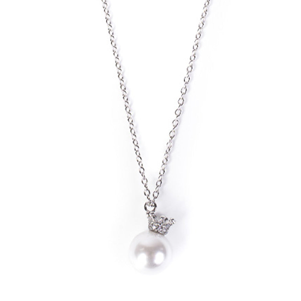 PEARL CHOKER NECKLACE HANGING ON A RHINESTONE CROWN