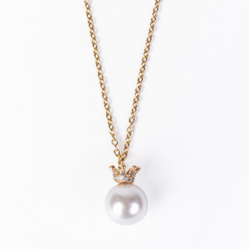 PEARL CHOKER NECKLACE HANGING ON A RHINESTONE CROWN