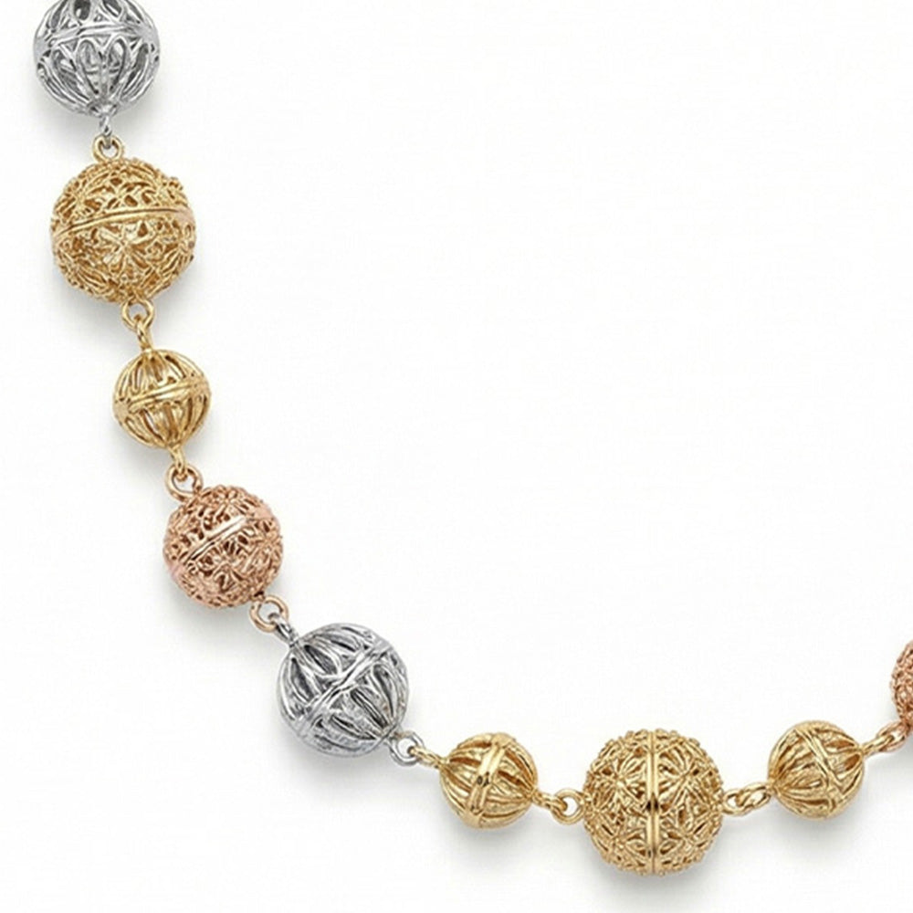 COLLANA LUNGA CON SFERE INTAGLIATE E CATENA