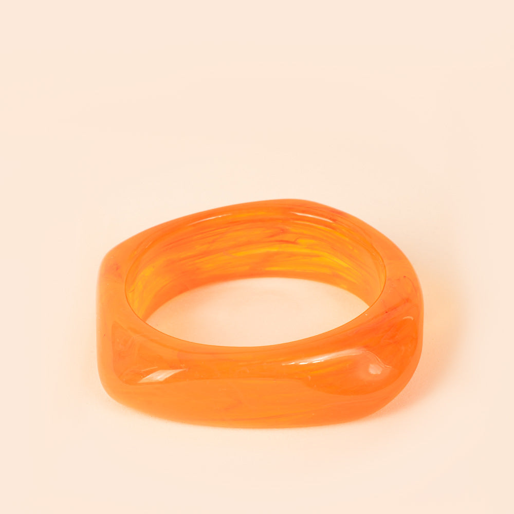 RIGID BRACELET OFTEN WITH AN IRREGULAR SHADE