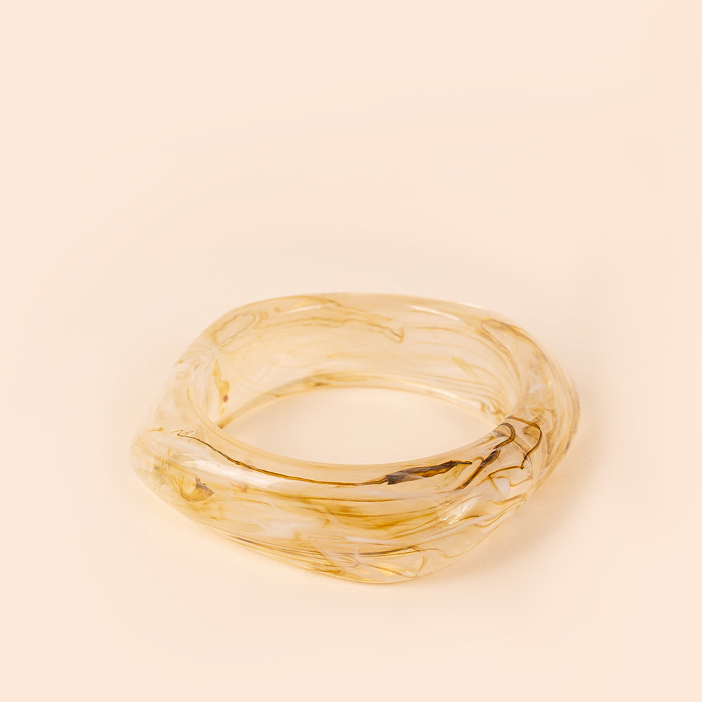 RIGID BRACELET OFTEN WITH AN IRREGULAR SHADE