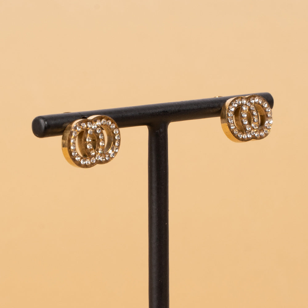STUD EARRINGS WITH TWO TWISTED DISCS AND RHINESTONE