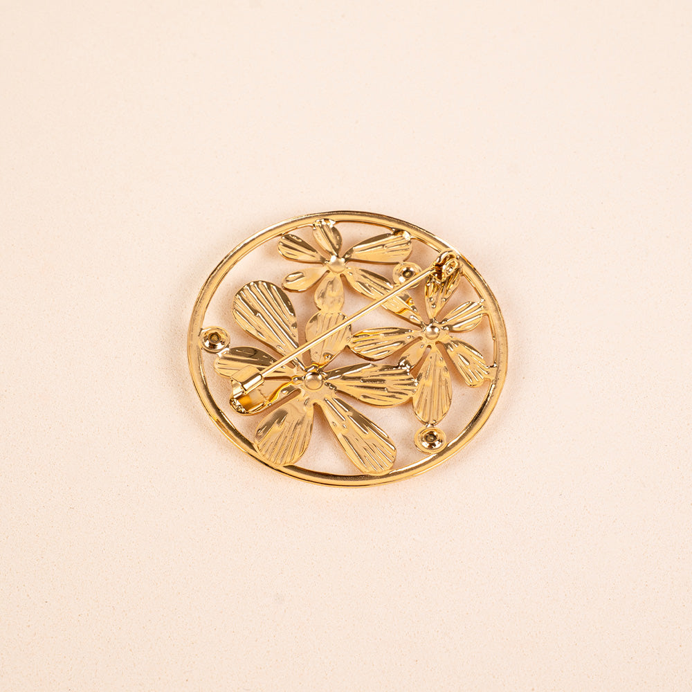 PIN WITH FLOWERS AND CIRCULAR FRAME
