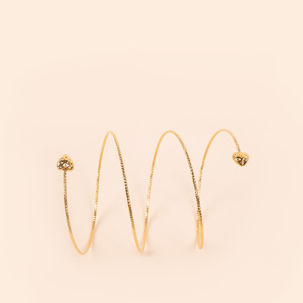 BRACCIALE RIGIDO MOBILE CON TRAMA SFACCETTATA E CUORI ALLE ESTREMITA'