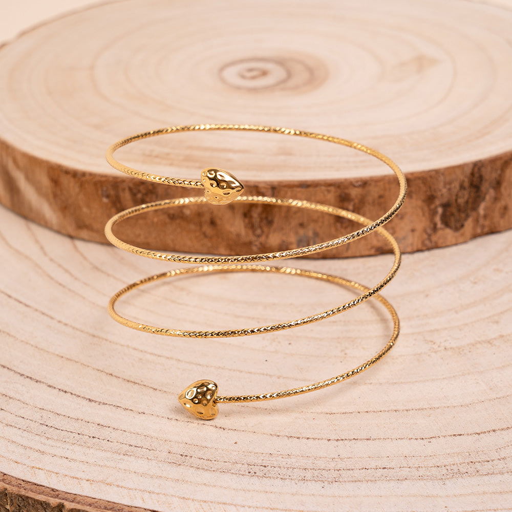 BRACCIALE RIGIDO MOBILE CON TRAMA SFACCETTATA E CUORI ALLE ESTREMITA'