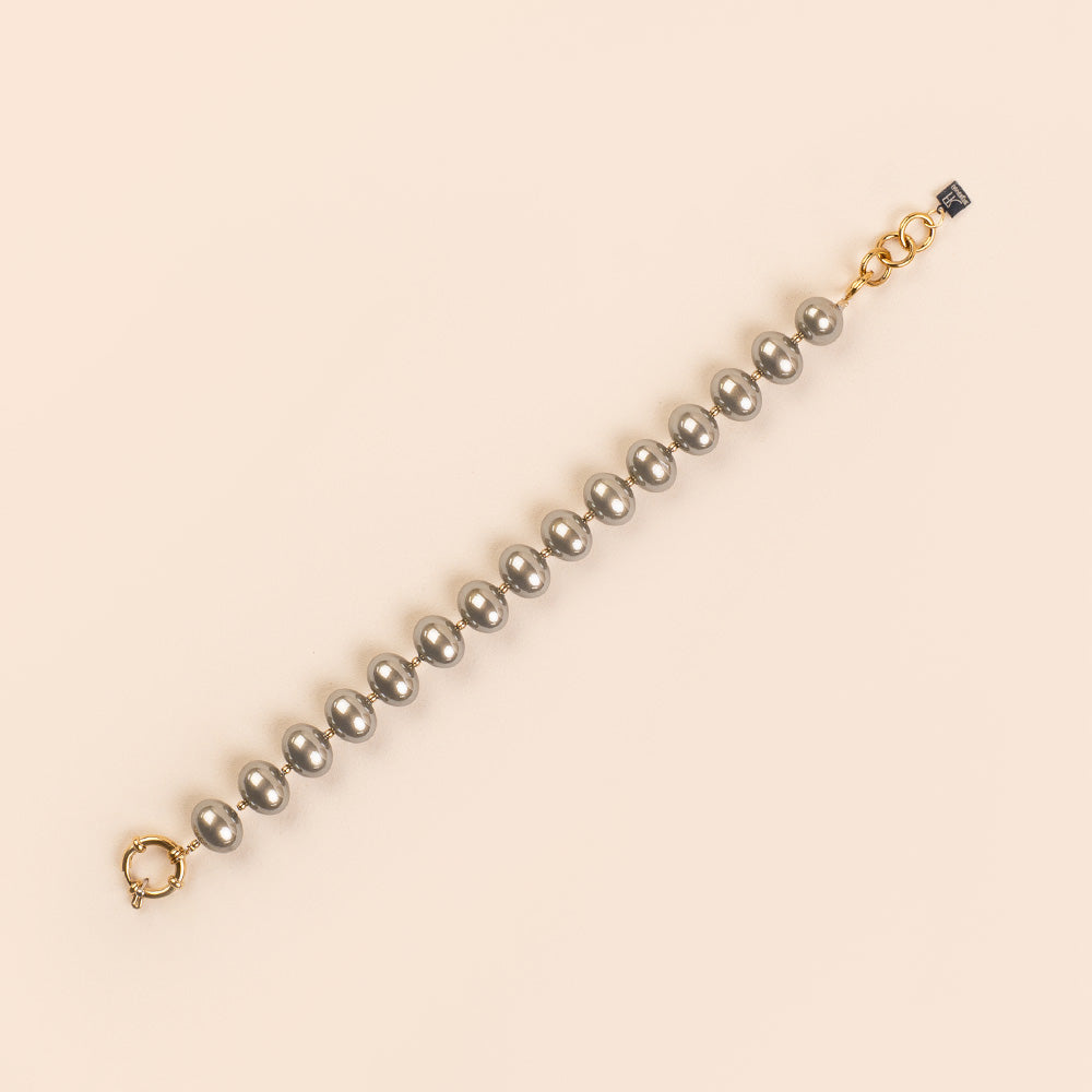 BRACCIALE CON PERLE OVALI LUCIDE INTERVALLATE DA PUNTI DORATI