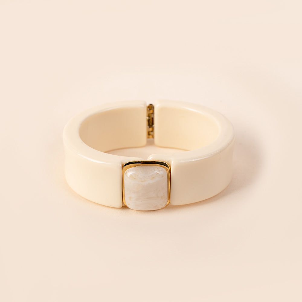 BRACCIALE RIGIDO IN RESINA CON APERTURA A MOLLA E PIETRA CENTRALE