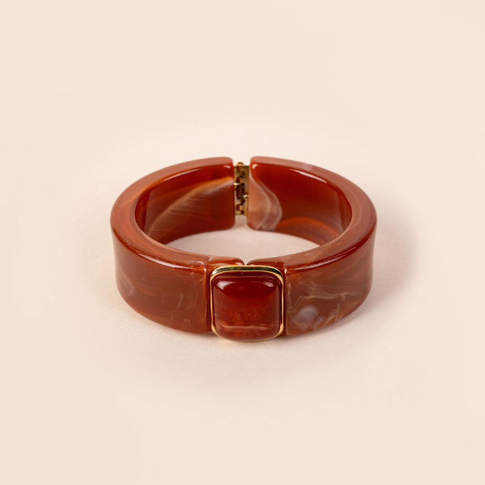 BRACCIALE RIGIDO IN RESINA CON APERTURA A MOLLA E PIETRA CENTRALE